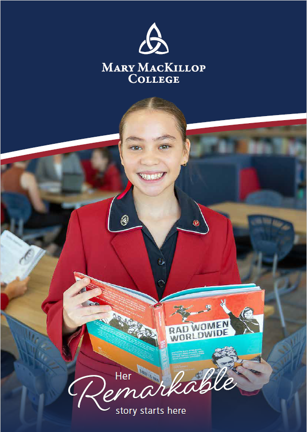 Student smiling and holding library book
