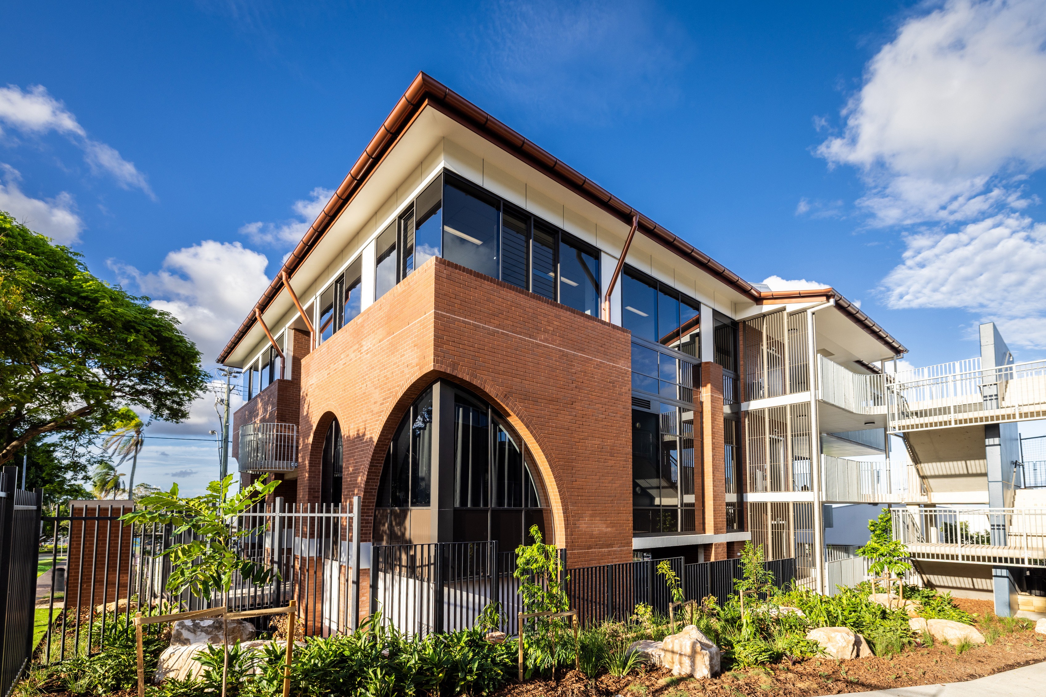 Modern multi‑storey school building with brick and glass architecture